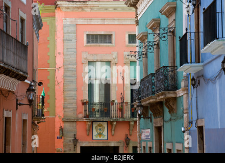 Bold and beautiful colors are painted on the walls of the houses in historic GUANAJUATO MEXICO Stock Photo