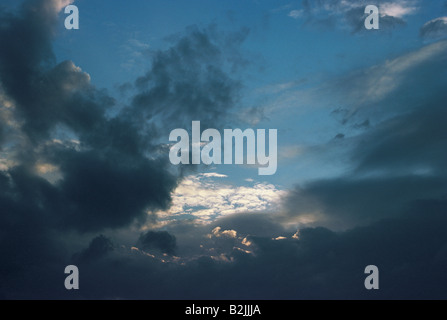 Heavy nimbostratus and altocumulus clouds gathering at dusk in a dark, forbidding sky. Stock Photo