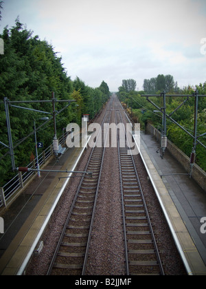 A view down the train track a long staight section of track Cambridgeshire UK Stock Photo