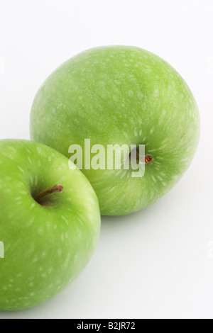 Close up of two green Granny Smith Apples isolated against a white background Stock Photo