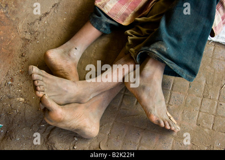 Tangled Feet of Homeless Boys Sleeping in the Streets of Mumbai India Stock Photo