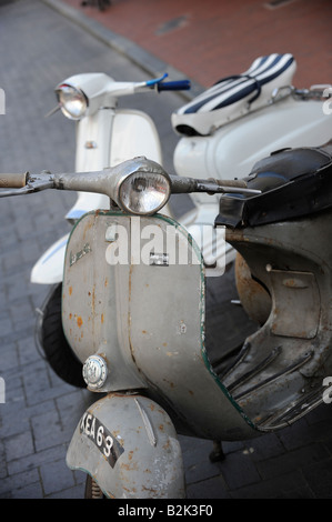 A pair of Vespa mopeds parked outside 'Jump the Gun' in Brighton city centre. Stock Photo