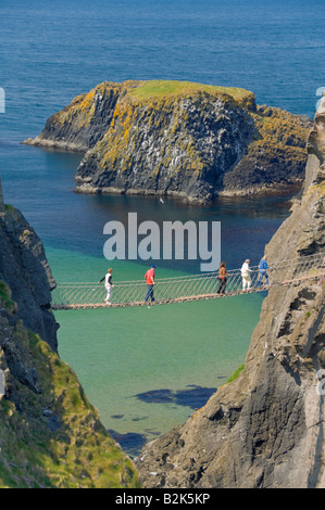 Tourists crossing the Carrick a rede rope bridge to Carrick island Ballycastle County Antrim Northern Ireland UK GB EU Europe Stock Photo