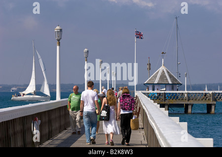 People strolling and relaxing on the pier Yarmouth Isle of Wight United Kingdom Stock Photo