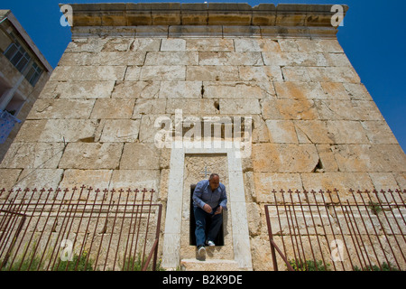 Iraqi Refugee Caretaker Bows to Exit Greek Catholic Saint Peters Church in Sednaya Syria Stock Photo