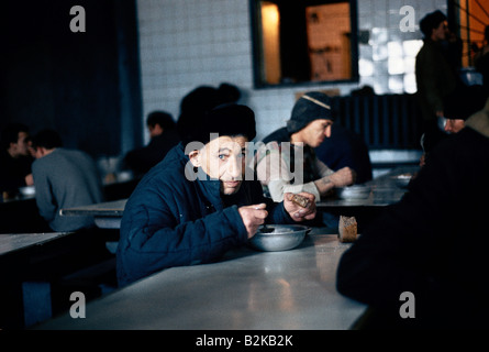 prisoners eating meal of bread and soup in a siberian prison canteen Stock Photo