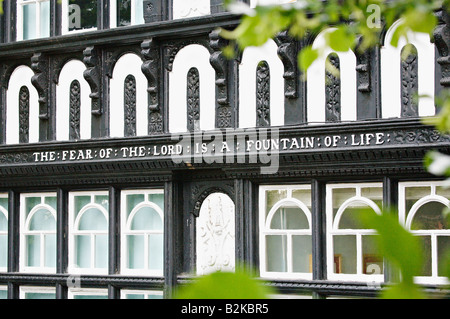 Religious motto on the wall of a black and white building in Chester England UK Stock Photo