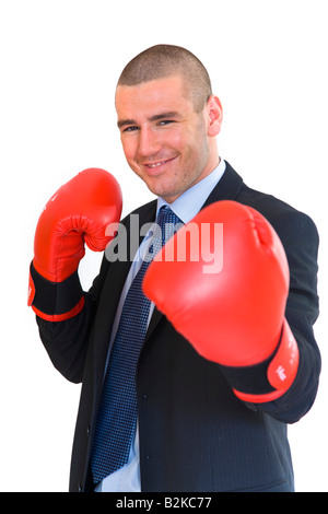 Young man in business suite wearing boxing gloves. Stock Photo