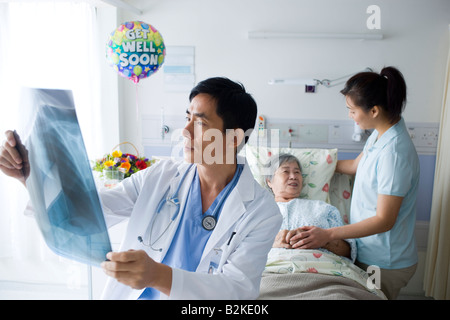 Male doctor examining at an X-Ray report Stock Photo