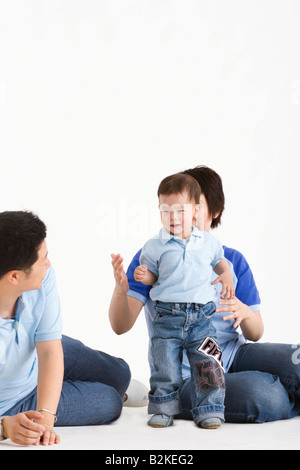 Mid adult couple playing with their son Stock Photo