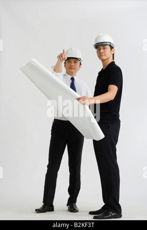 Two male architects discussing on a blueprint Stock Photo
