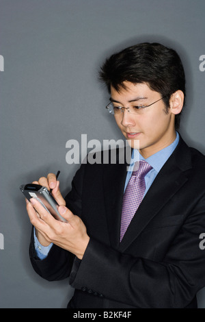 Close-up of a businessman using a personal data assistant Stock Photo