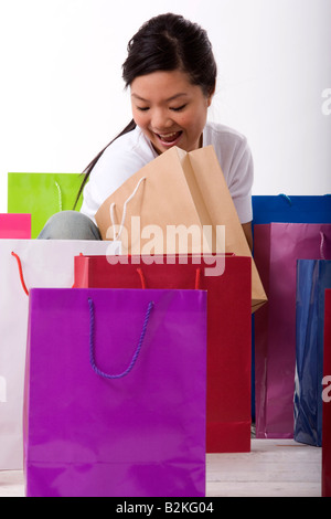 Young woman looking into a shopping bag Stock Photo