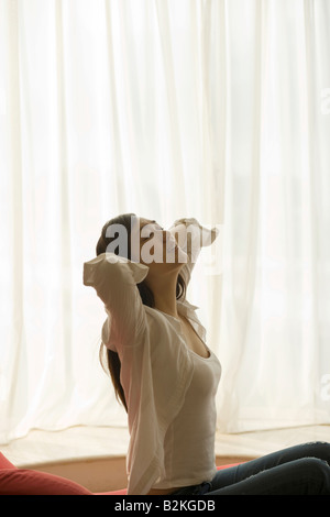 Side profile of a young woman waking up Stock Photo