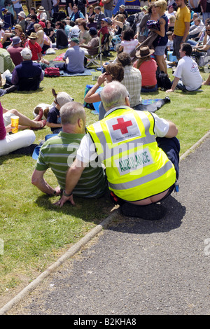 First Aid Paramedic helping a man who has fallen and twisted his ankle Stock Photo
