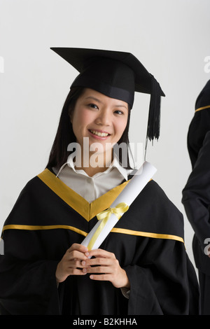 Portrait of a smiling toothy student holding a textbook Stock Photo - Alamy
