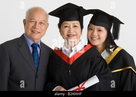 Portrait of a professor with his two female university students smiling Stock Photo