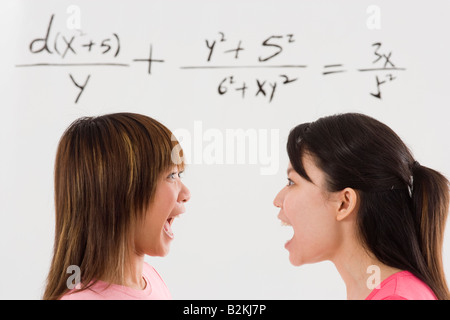 Close-up of two young women shouting at each other Stock Photo