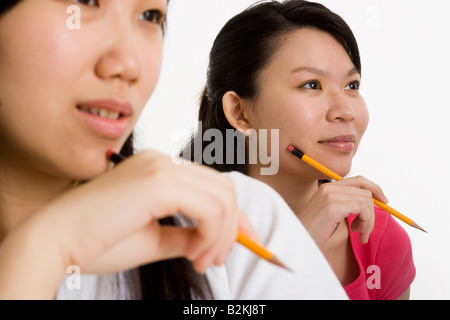 Two young women studying in a classroom Stock Photo