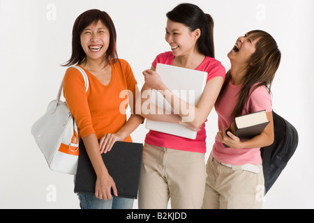 Three female university students smiling together Stock Photo