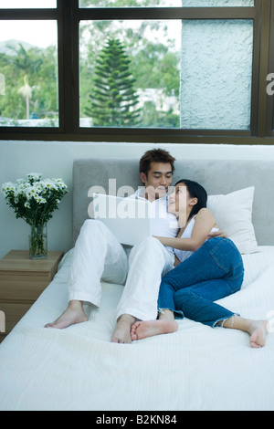 Couple reclining on the bed Stock Photo