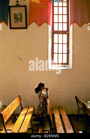 french polynesia rangiroa the tuamotus islands girl praying in a catholic church at avatoru 1995 Stock Photo