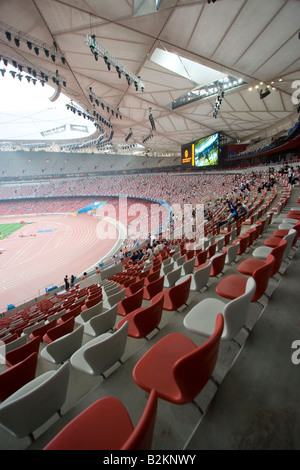 Beijing China View inside the Olympic stadium in Beijing with red and white seats and huge digital display Stock Photo