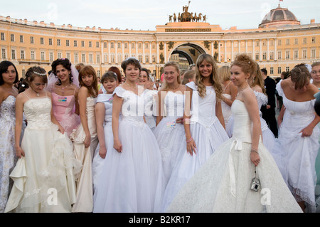 Group of young women wearing wedding dresses in Dvortsovaya Ploshchad, St Petersburg, Russia Stock Photo