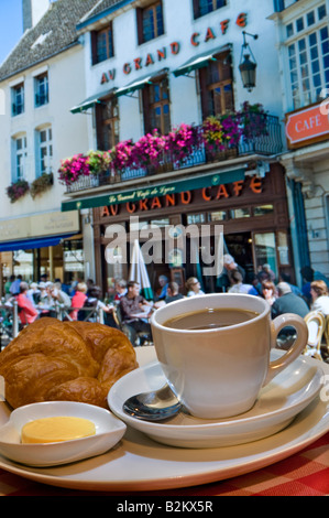 Typical continental breakfast of coffee and croissant overlooking Au Grand Café, in central sunny Beaune, Burgundy,France Stock Photo