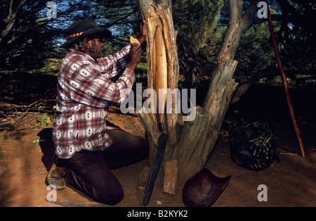 Carving spear thrower, outback Australia Stock Photo