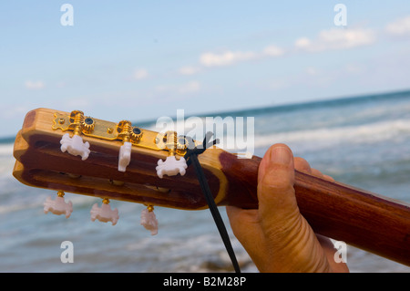 Guitar neck against the backdrop of the sea Stock Photo