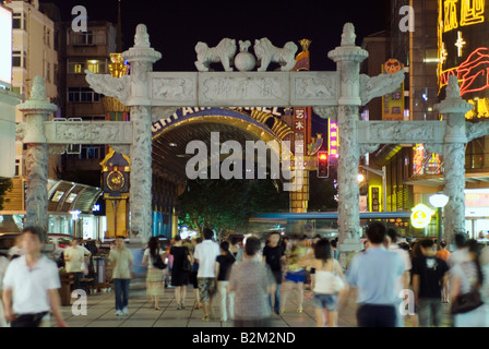 China, Nanjing, Hunan Road old stone gateway to pedestrian area at night Stock Photo