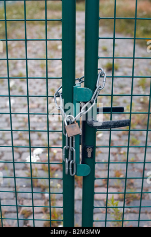 Gate secured with a chain and a lock. Stock Photo