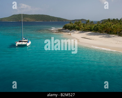 A cruising catamaran anchored next to uninhabited Sandy Cay in the British Virgin Islands. Stock Photo