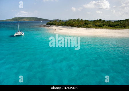 A cruising catamaran anchored next to uninhabited Sandy Cay in the British Virgin Islands. Stock Photo