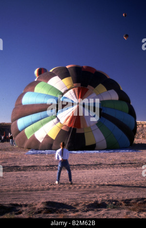 Person holds balloon down at Hot Air Balloon Race Albuquerque New Mexico United States Stock Photo