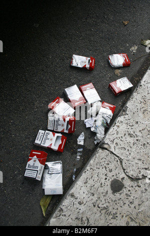 lots of cigarette packs left on street road Stock Photo