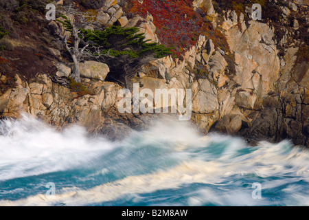 Turquoise colored waves crash into Headland Cove at Point Lobos State Reserve near Carmel California, United States Stock Photo