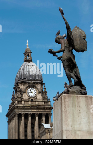 Leeds town hall clock tower seen beyond the war memorial angel sculpture Stock Photo