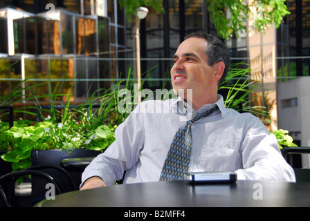 Businessman relaxing in outdoor cafe after work Stock Photo