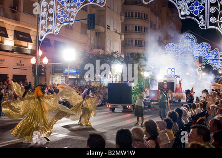 Costa Blanca Spain Alicante Fogueres de San Juan summer fiesta carnival dancers in the street at night Stock Photo