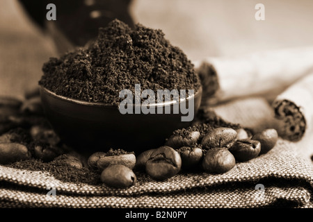 freshly ground coffee beans cinnamon sticks in sepia Stock Photo