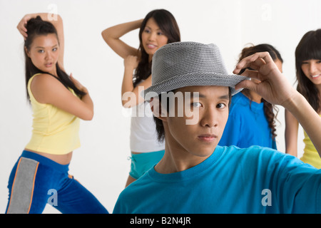 Close-up of a young man dancing with four young women Stock Photo