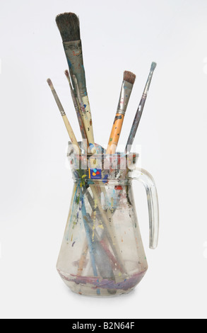 selection of used paint brushes in a jug Stock Photo