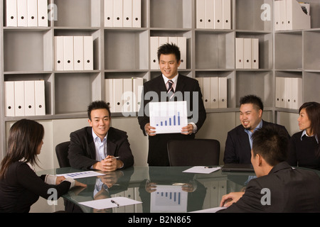 Business executives discussing a bargraph in an office Stock Photo