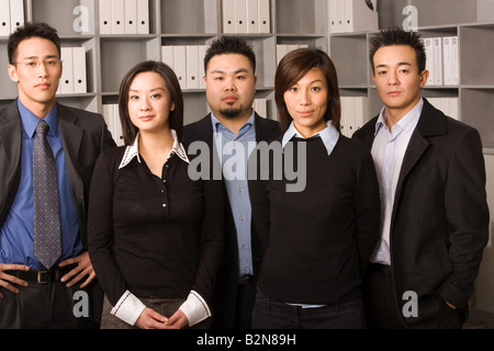 Portrait of two businessmen standing with two businesswomen in an office Stock Photo