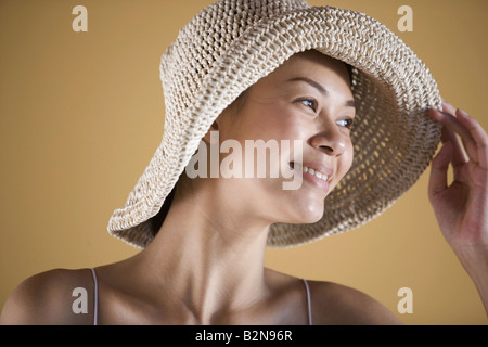 Close-up of a young woman wearing sunhat and smiling Stock Photo