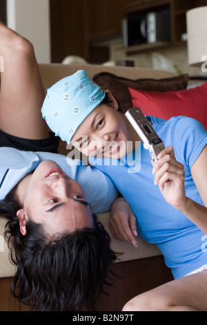 Young couple looking at a mobile phone and smiling Stock Photo