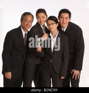 Portrait of two businessmen standing with two businesswomen Stock Photo