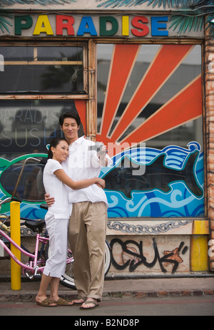 Young couple filming themselves with a home video camera, Huntington Beach, California, USA Stock Photo